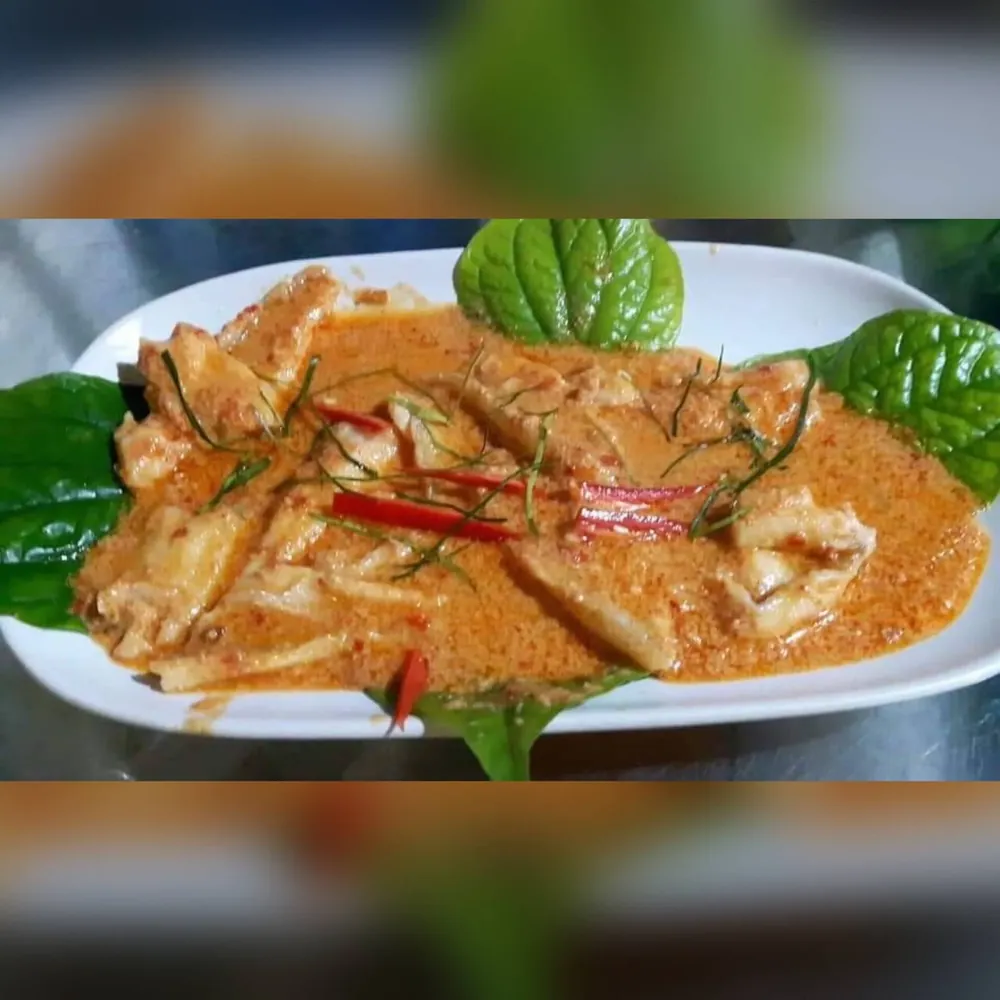 Choo chee curry over fish, with kaffir lime leaf and red chilli.